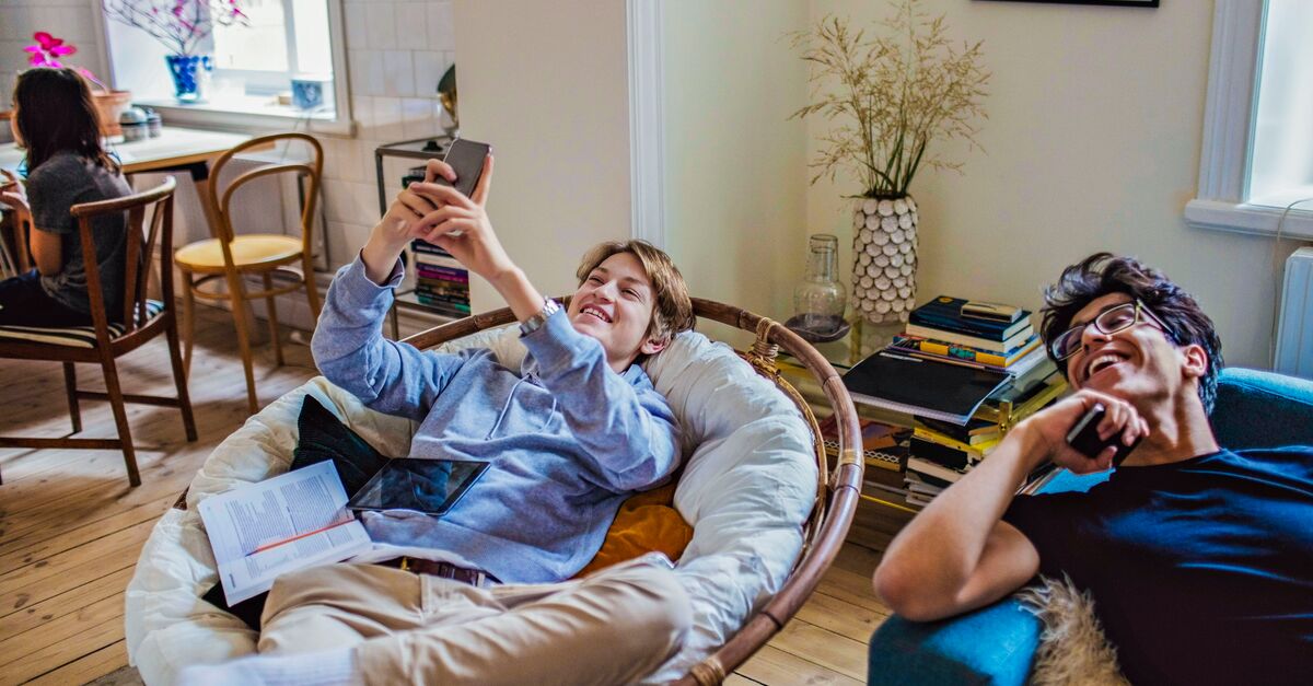 LinkedIn and Facebook Two people laughing as they relax in their home (1)