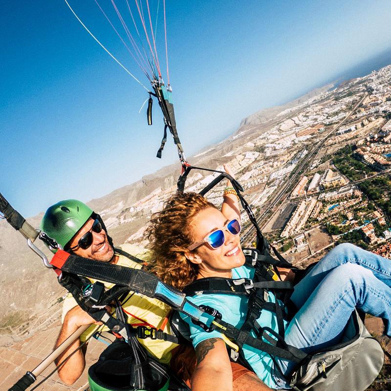 Low angle view of people on mountain against sky