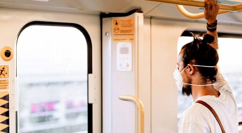 Medium MS PPT MS Word Newsletter A young man with a bun is wearing a mouth mask in the subway.