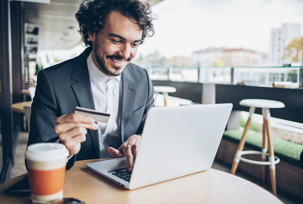 Man is smiling while use his laptop