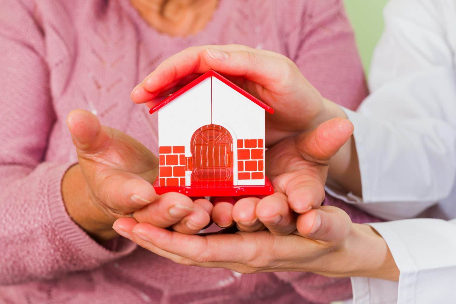 Old couple are holding a toy in the hands