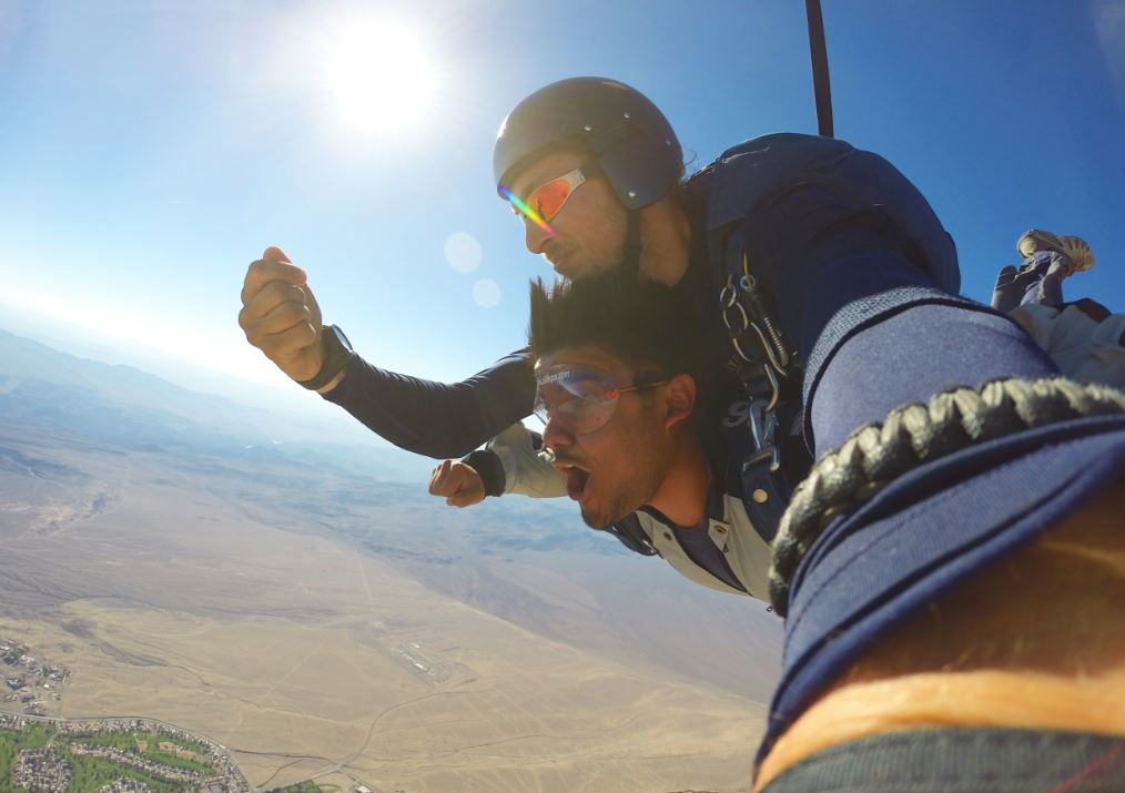 Two man are falling down with their parachute