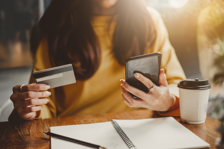 Girl is paying something with her telephone