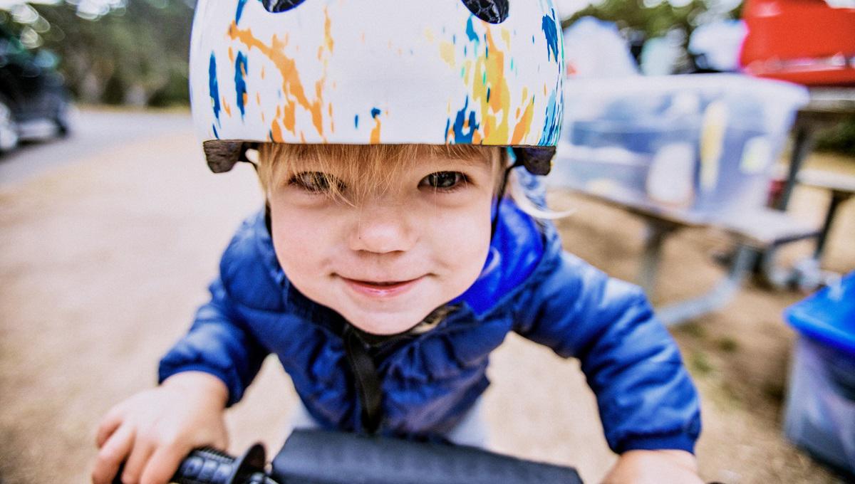 Young boy wearing helmet on bicycle